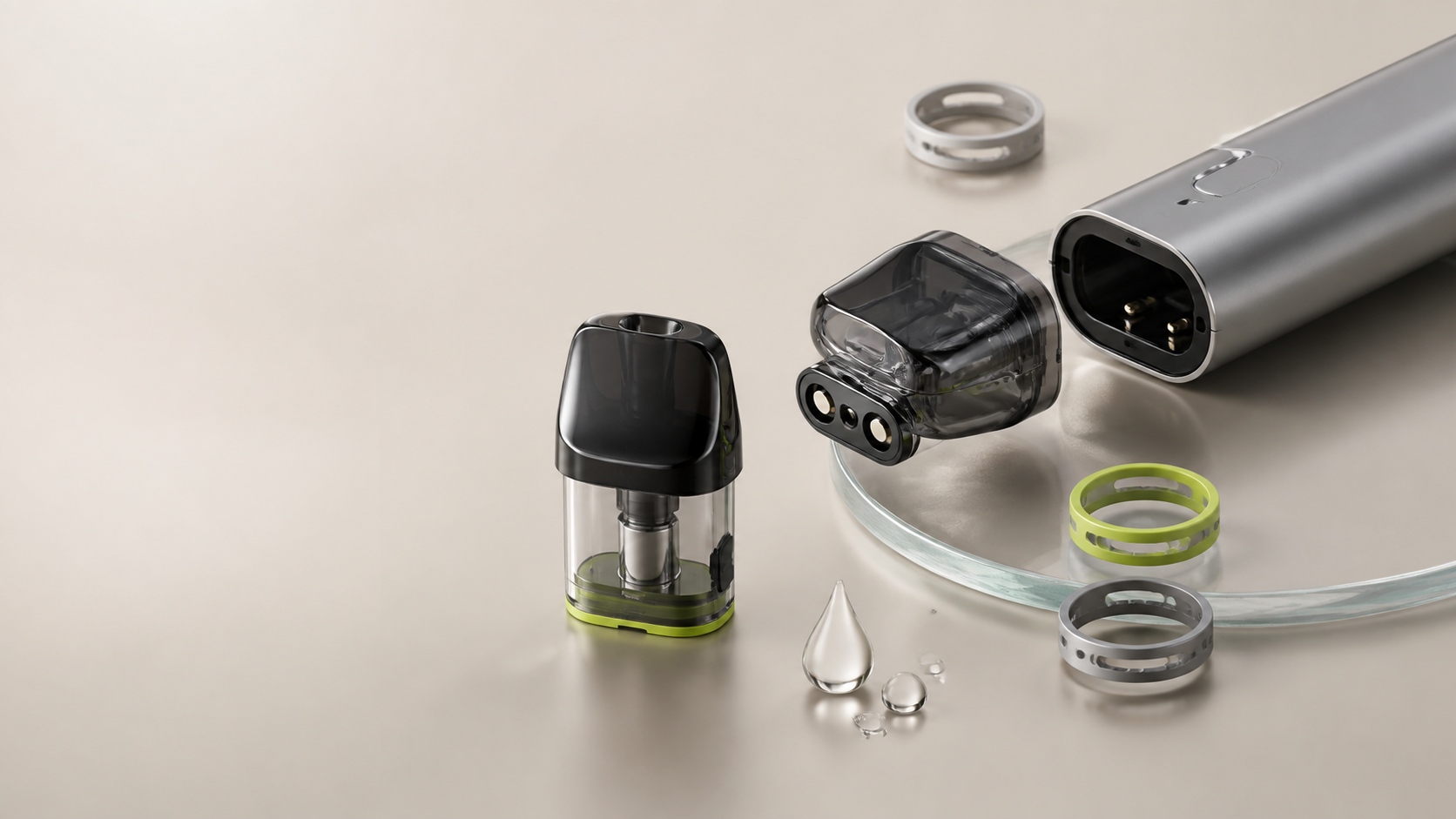 Silver pod vape with detached transparent pods and liquid droplets on a neutral surface